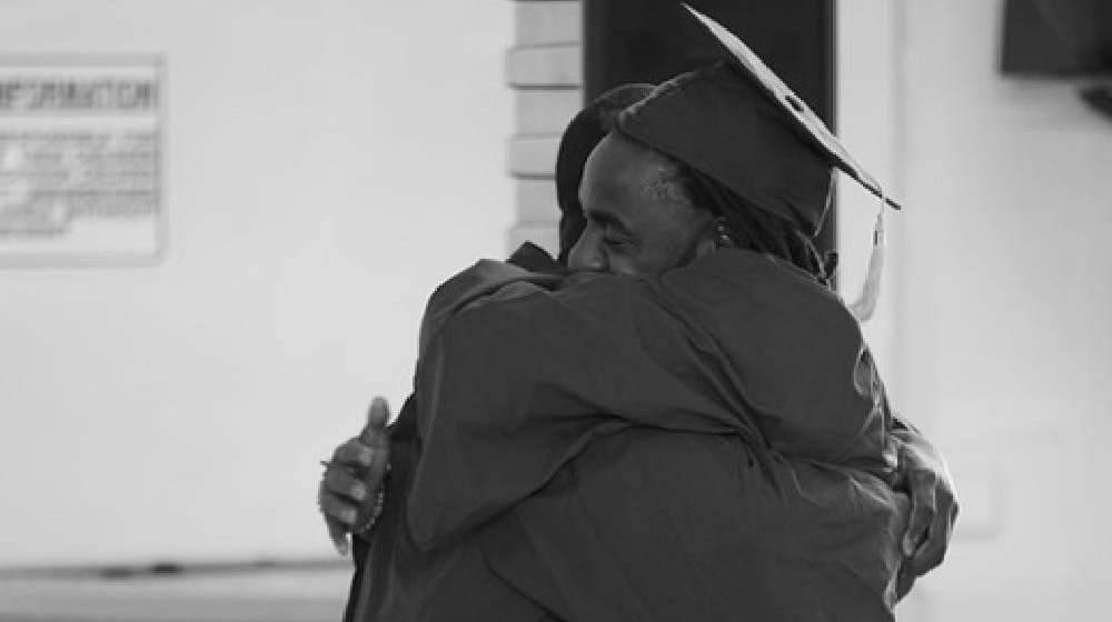 Defy Ventures program participants embracing after a milestone<br />
moment.