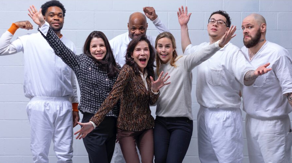 PEP volunteers and program participants celebrating inside a correctional facility.